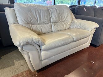 Cream Colored Leather Loveseat with Plush Rounded Arms