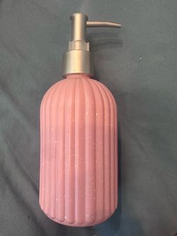 New pink soap dispenser, filled with fragrance hand  soap