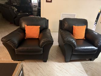 Beautiful Genuine, leather Sofa, plush chairs and solid wood accessories.