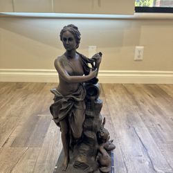 Bronze Statue on Marble Stand  20  inches tall .