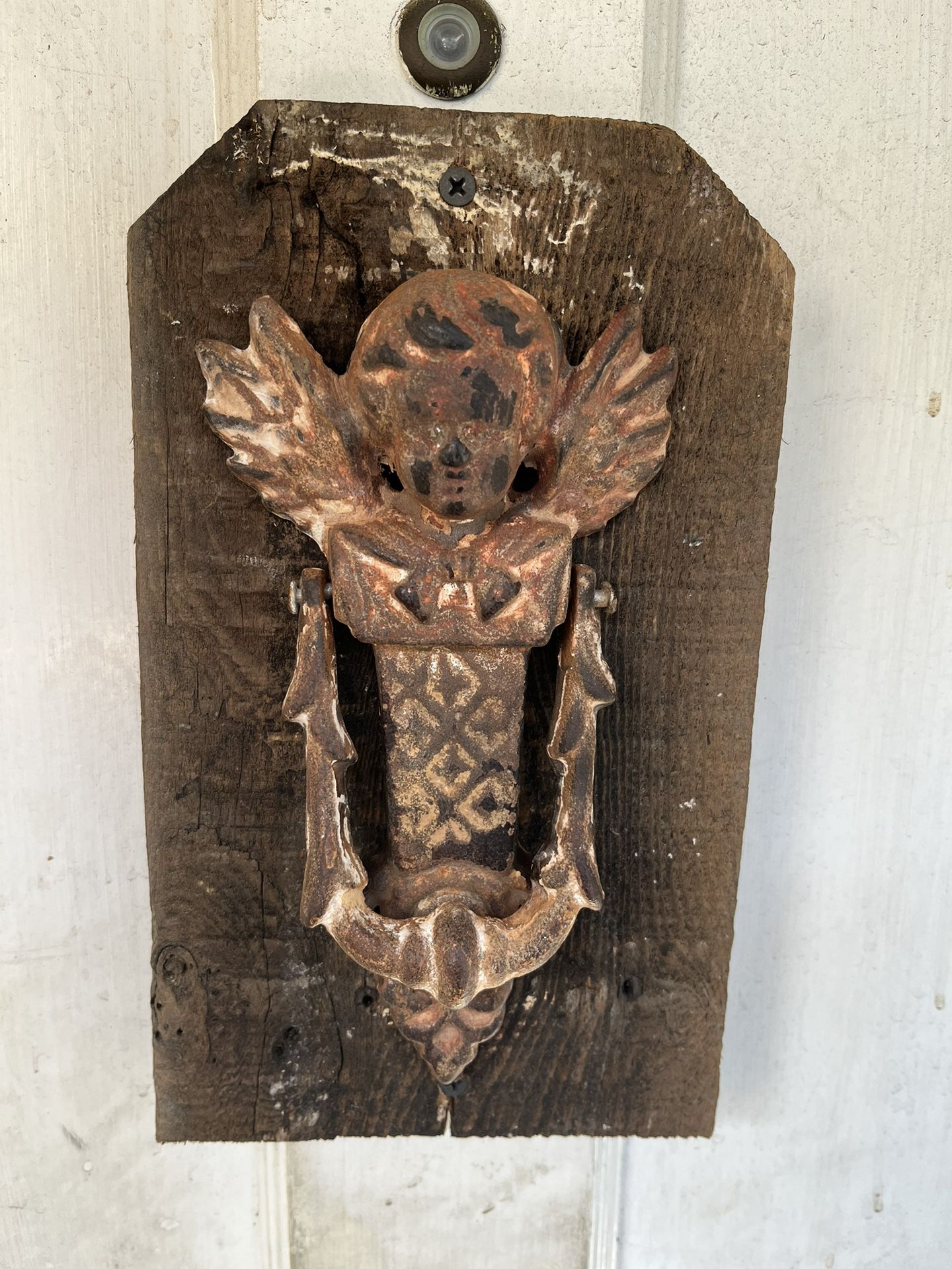 Antique Cast-Iron Cherub Angel Door Knocker Mounted on Vintage Wood — 8” x 4.5” Knocker, 6” x 10” Base ⸻ Description: This striking antique cast-ir