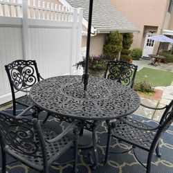 Wrought Iron Table and Chairs With Seat Cushions And Umbrella And Stand
