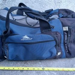 This is a blue and black High Sierra duffel bag. 