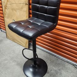 Adjustable black cushioned bar stool
