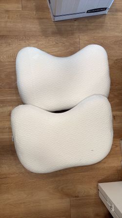 Two memory foam pillows shaped for side sleepers
