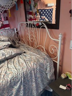 Queen size white metal bed frame.