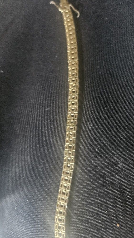 Silver brace of a gold overlay