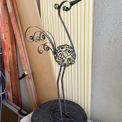 Peacock lawn sculpture inside outside