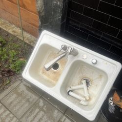 Used white kitchen sink with faucet.. everything works need to clean and paint 