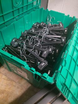 Green tote containing 112 adult size pant hangers, all are in working condition and none are broken