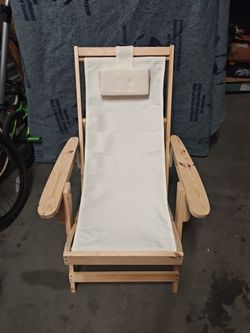 Sling Chair With a Natural Frame And Beige Cushion