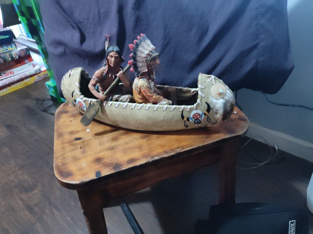 2 Natives In a Canoe