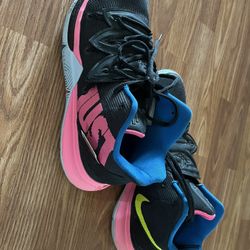 The Nike Kyrie 5 "Just Do It" is a basketball sneaker designed for Kyrie Irving, featuring a prominent "Just Do It" slogan on the midsole in hyper pin