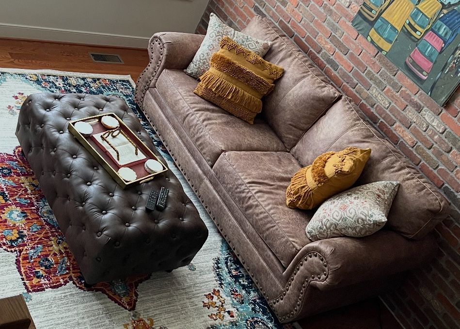 Sofa & ottoman with pillows.