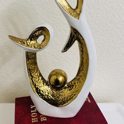 abstract art ceramic statue frequently sold as home decor for dining rooms, living rooms, or offices.