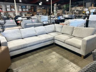 L-shaped light grey fabric sectional sofa from Costco