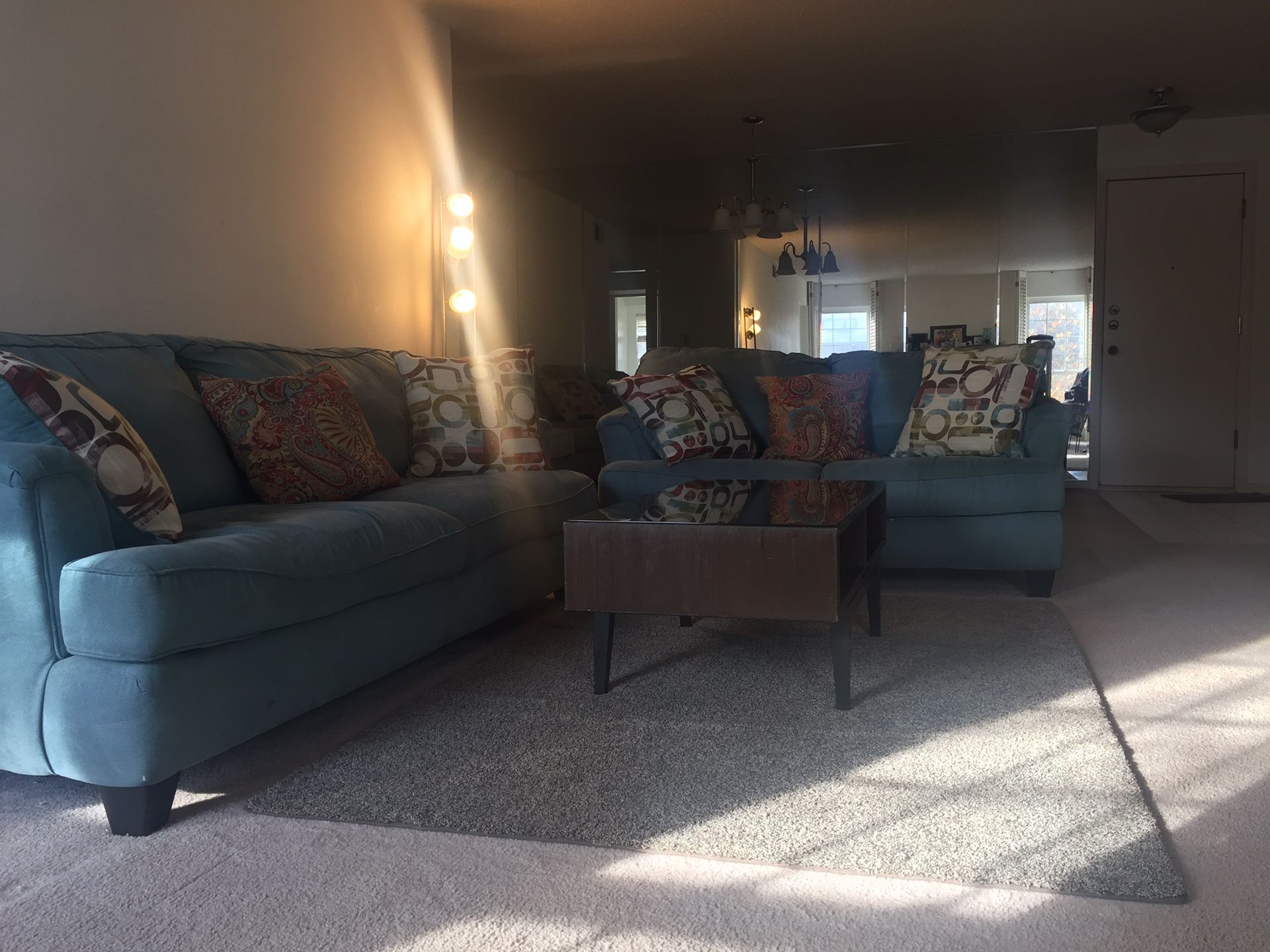 Two sofa, a coffee table, and blue rug.