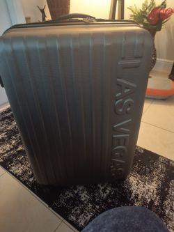 Polycarbonate hardside suitcase that features a large "LAS VEGAS" graphic text! Very big! measures 27 x 19 x 12.25 inches of packing space.
