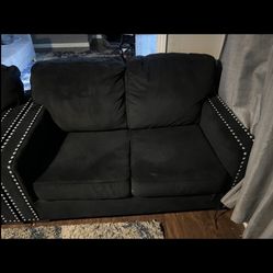 Two Sets Of Black Sofas 