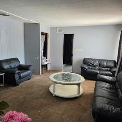 Real Leather Black Sofa Loveseat And Chair With A Coffee Table And A TV Stand $350