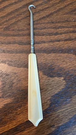 Vintage celluloid vs ivory button hook