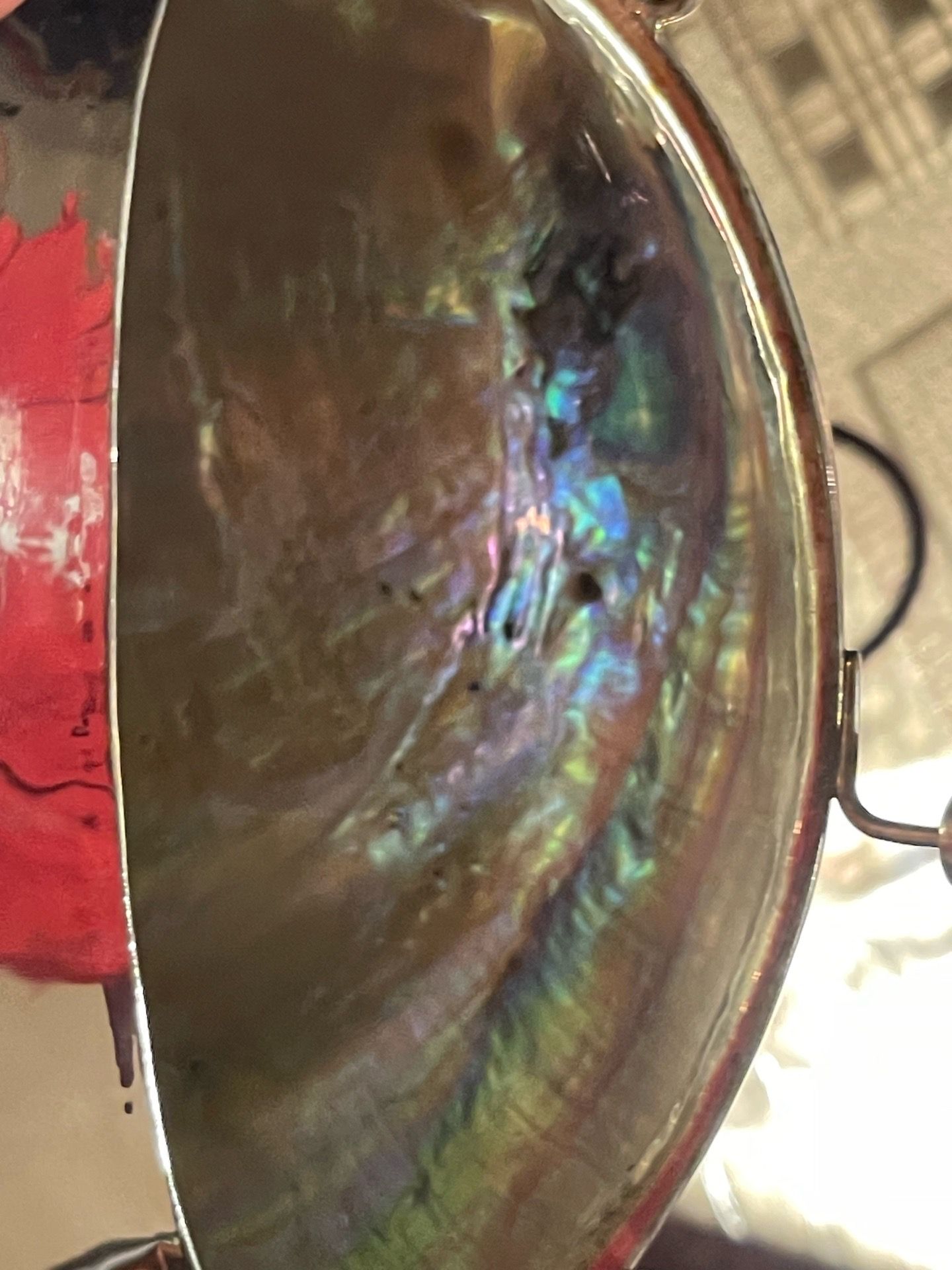 mother-of-pearl inlay and a metal frame/clasp. The pearl-bead strap and the iridescent shell top are classic details often seen in mid-century or retr