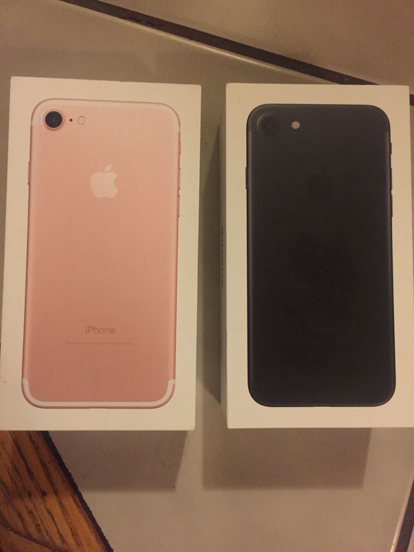 Black iPhone box and rose gold iPhone box