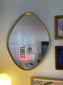 Beautiful gold framed organic shape mirror