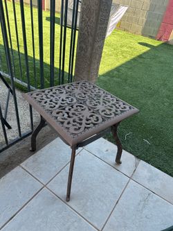 small ornate cast iron outdoor side table