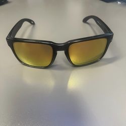 Oakley Holbrook OO9102-N855 Sunglasses - Matte Black Frame with Gold Lenses  This listing is for a pair of Oakley Holbrook sunglasses, a timeless and 