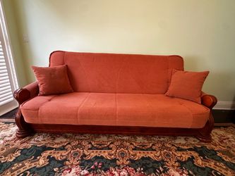 Beautiful carved wood sofa bed in coral peach color