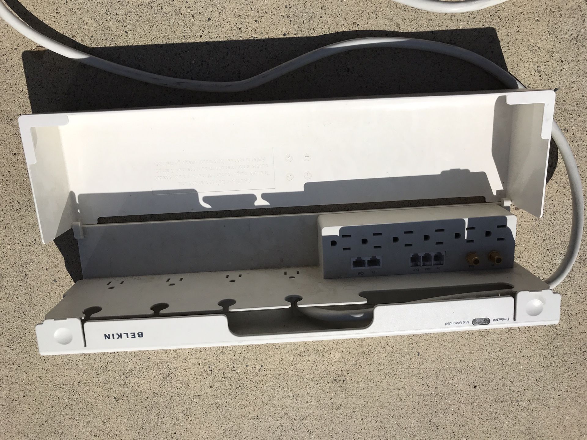 Belkin power surge protector with 11 outlets, protective cover, and long cable