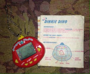 GENTLY USED - VINTAGE RAKU RAKU DINO KUN “DINKIE DINO” VIRTUAL PET GAME