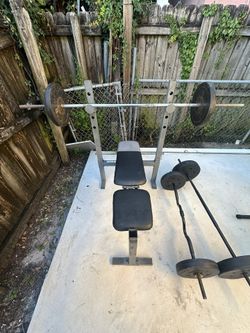 Bench With A Bar And 2x25 Lbs And 2x10 Plates