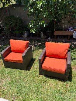 Patio furniture chairs with cushions.