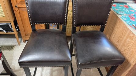 Two beautiful black leather barstools