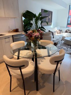 Round glass table + boucle chair