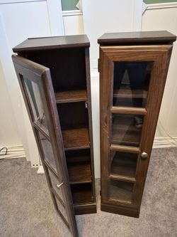 CD/DVD or Curio Cabinet . 2 available.  Solid wood with glass doors