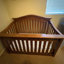Wooden crib with mattress