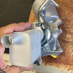 Engine oil cooler with oil filter, housing assembly