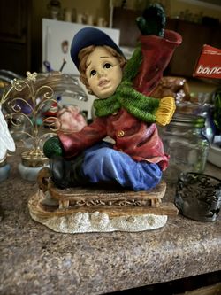 Boy Riding A Sled 