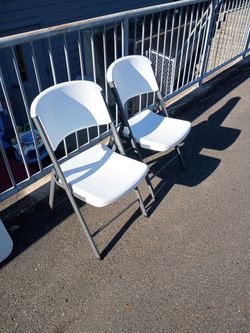 2 plastic folding chairs
