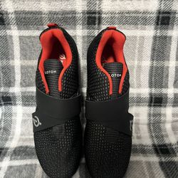 Black Peloton shoes with a single wide strap