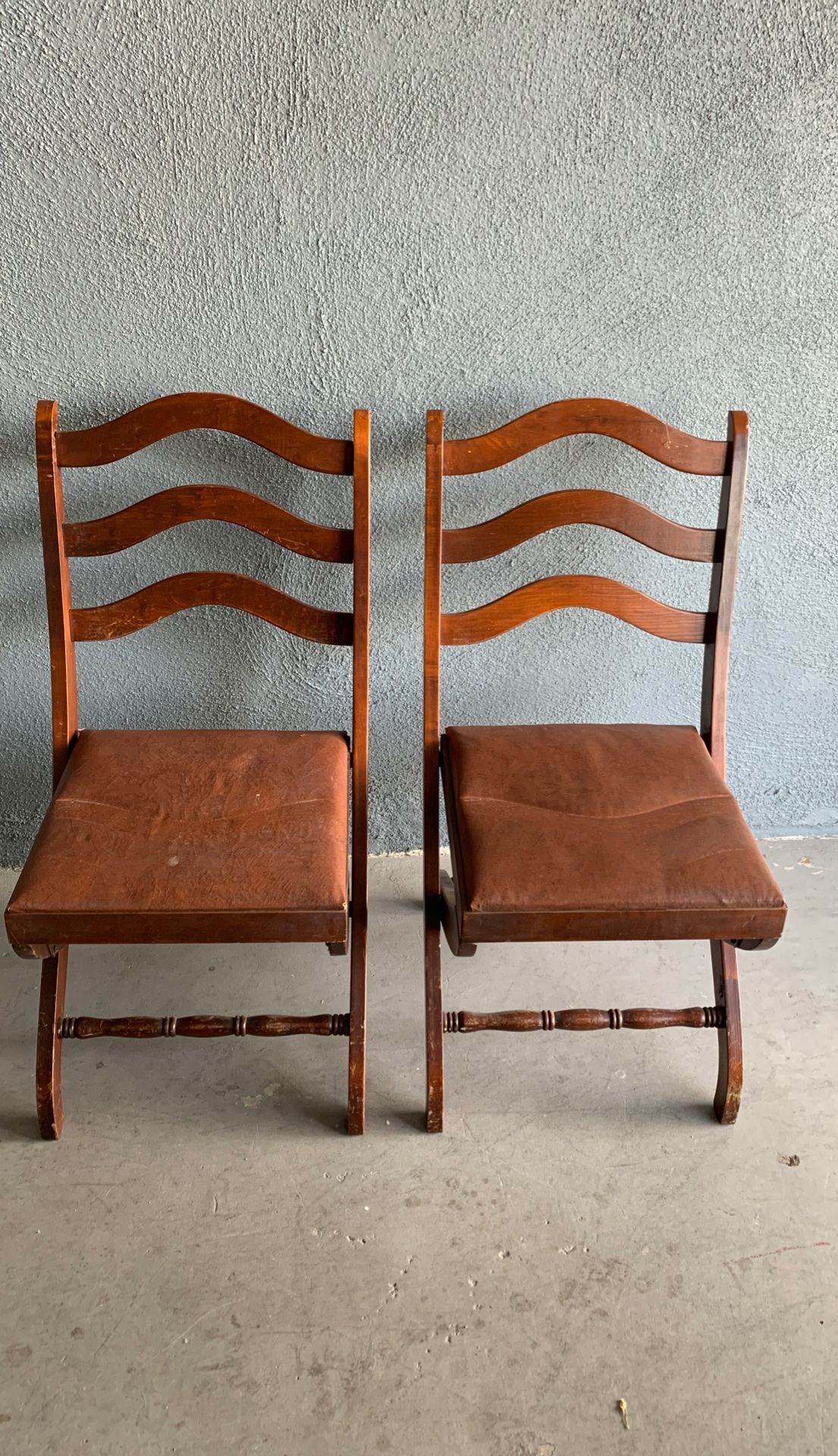 Two wooden antique folding chairs