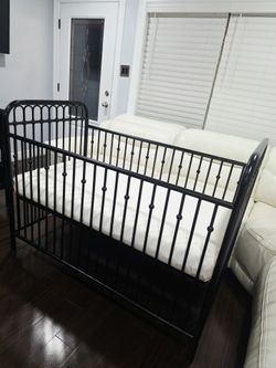 Black Metal Baby Crib With Mattress Included.