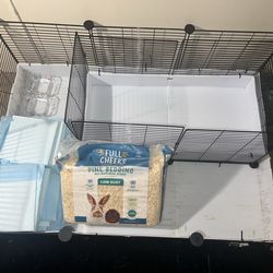 Guinea pig cage with supplies
