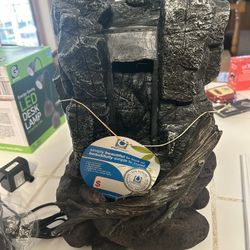 tabletop water fountain designed to look like a stone rock formation. It includes built-in LED lighting to create a peaceful ambiance. It is designed 