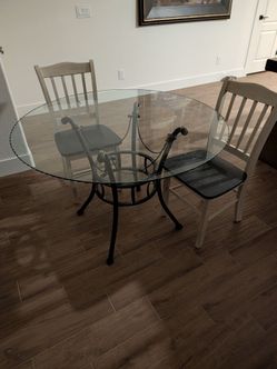 Glass table with two chairs