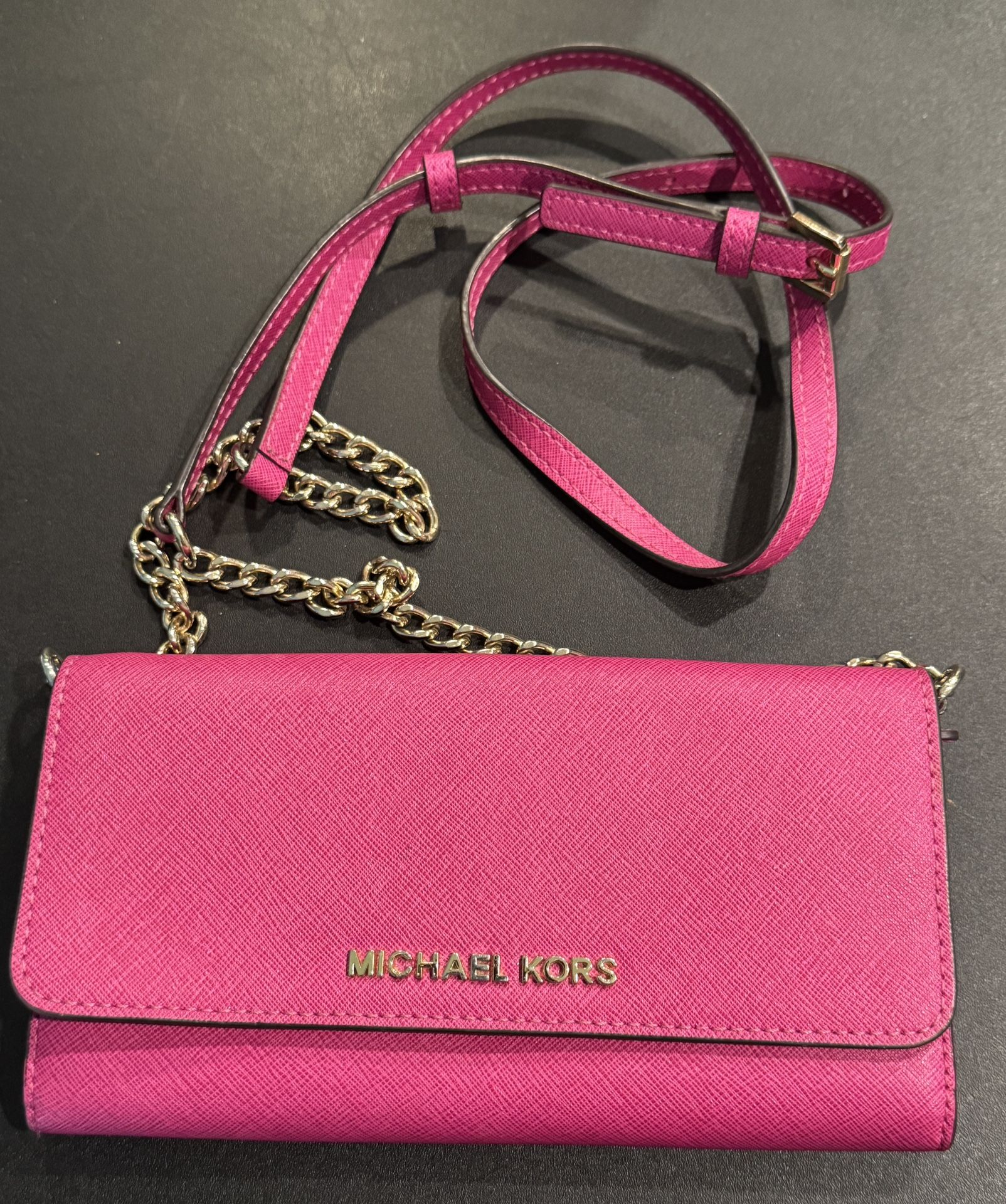 Michael Kors Saffiano Leather Travel Wallet Fuchsia With Chain & Leather Strap  This Michael Kors travel wallet in fuchsia is a stylish and functional
