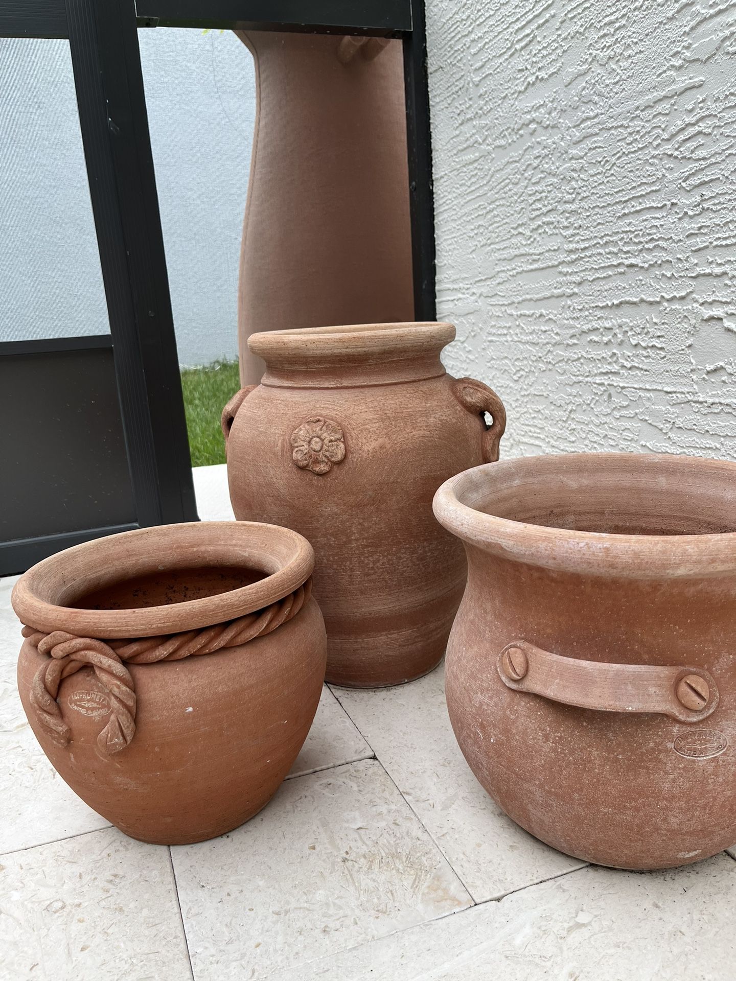 A Set of Three Impruneta Terracotta Planters